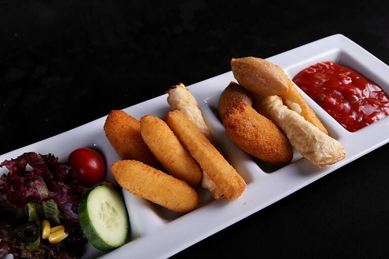 Snack platter: mozzarella stick, içli köfte, potato croquettes, sigara böreği, Mediterranean greens and salsa