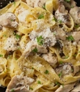 Fettuccine Alfredo with julienne chicken, mushrooms, basil sauce and cream