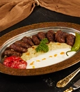 Balkan köfte with beğendi, roasted tomatoes, and pepper yogurt