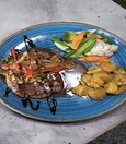 Beef tenderloin with creamy mushroom sauce, fries and boiled vegetables